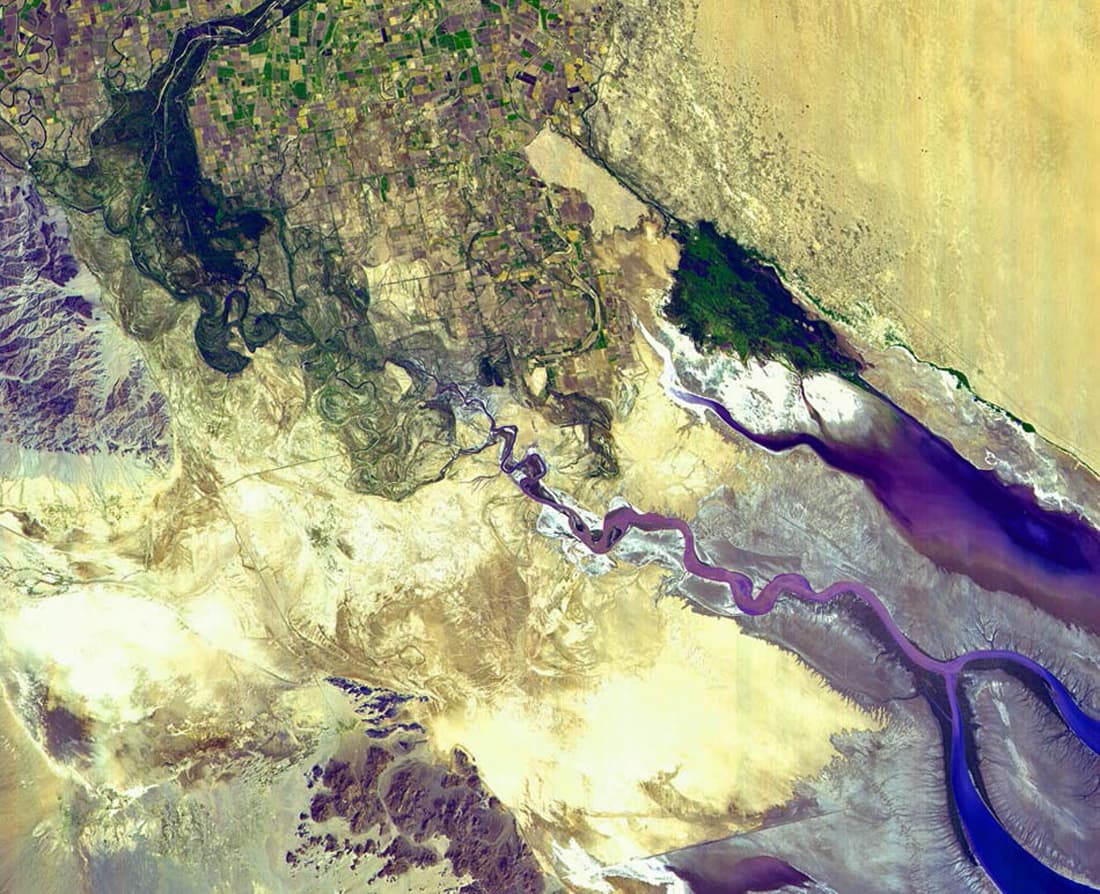 Satellite photo of the Colorado River's end in Mexico: green farmland at the top left, the river thinning to nothing in pale desert, and the Gulf of California reaching in from the lower right.